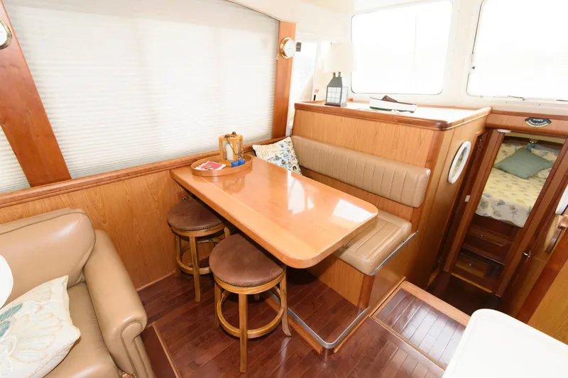 Slide: The Image of Interior of 2005 Mainship 400 Trawler with dining table and seating area. - 15