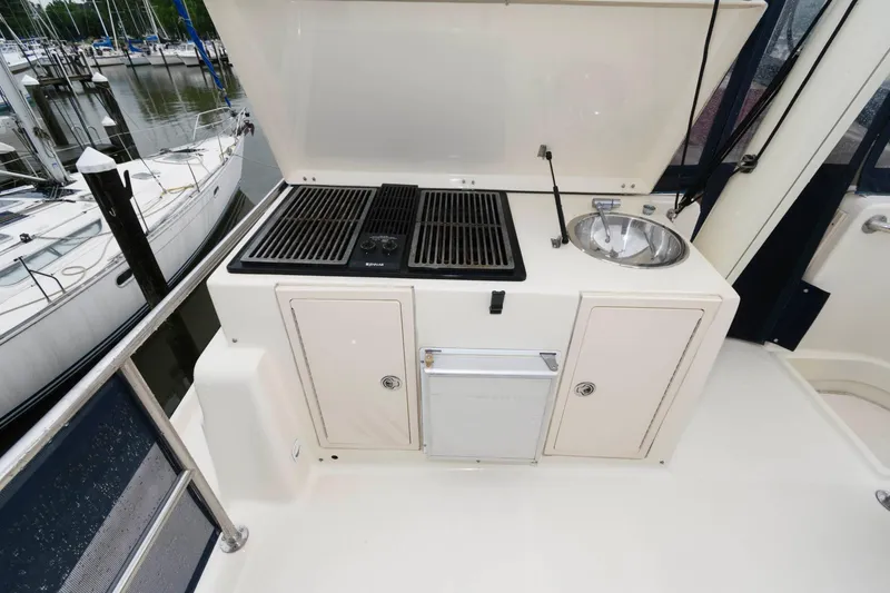 Slide: The Image of Outdoor kitchen on a 2005 Mainship 400 Trawler with grill and sink. - 8
