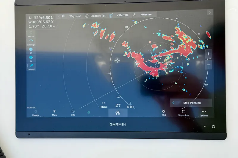Slide: The Image of Garmin marine radar display on 2019 Regulator 31 boat, showing weather patterns and coordinates. - 11