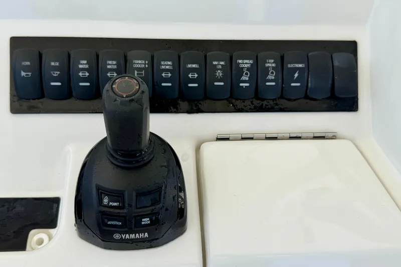 Slide: The Image of Control panel of a 2019 Regulator 31 boat with Yamaha joystick and switches. - 15