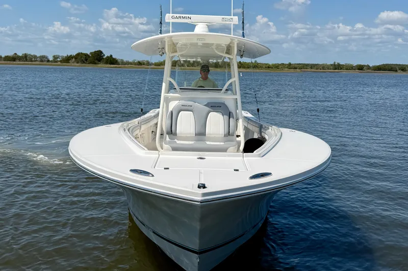 Slide: The Image of 2019 Regulator 31 boat on calm water under a clear sky. - 2