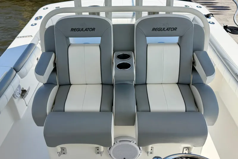 Slide: The Image of 2019 Regulator 31 boat seats with cup holders, featuring gray and white upholstery. - 26