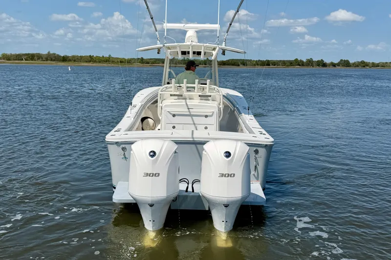 Slide: The Image of 2019 Regulator 31 boat with dual 300 horsepower engines on calm water. - 3