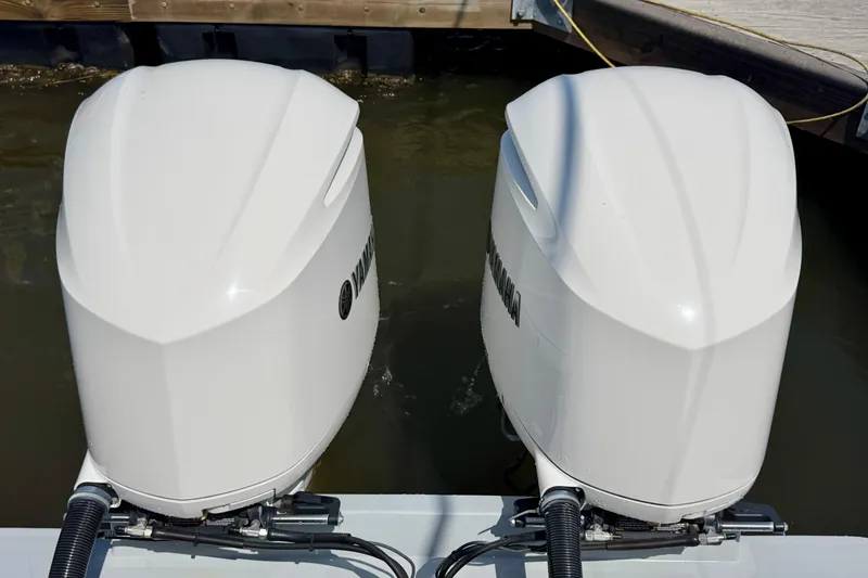 Slide: The Image of Twin Yamaha outboard engines on a 2019 Regulator 31 boat, docked in water. - 30