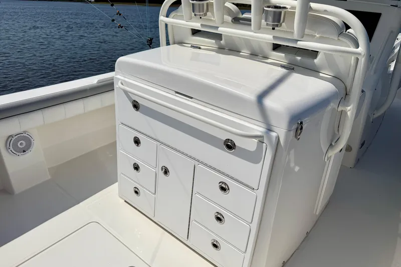 Slide: The Image of 2019 Regulator 31 boat interior with storage drawers and rod holders. - 31