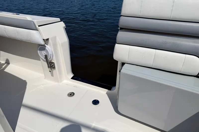 Slide: The Image of 2019 Regulator 31 boat interior with cushioned seating and water view. - 34