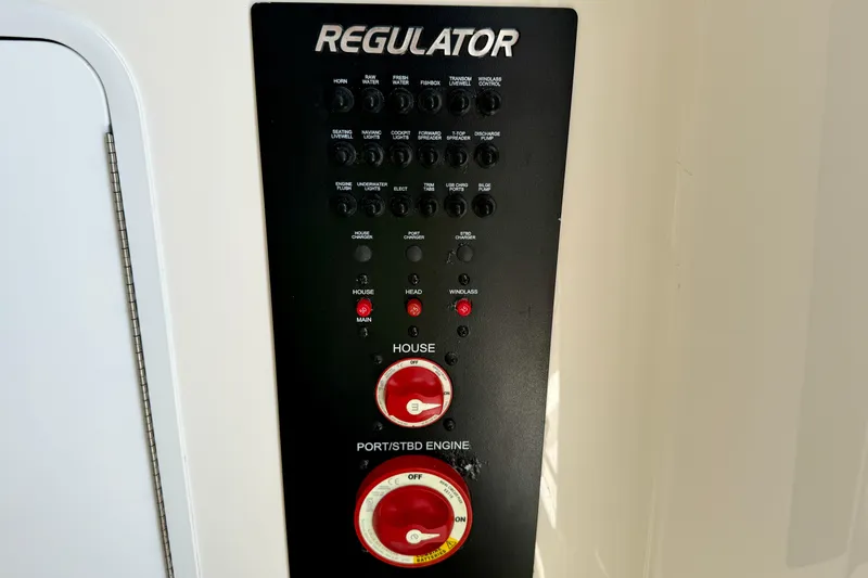 Slide: The Image of Control panel of a 2019 Regulator 31 boat with switches and dials. - 45