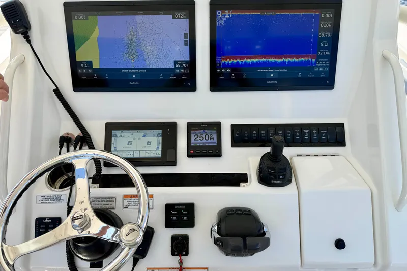 Slide: The Image of Control panel of a 2019 Regulator 31 boat with Garmin displays and steering wheel. - 9