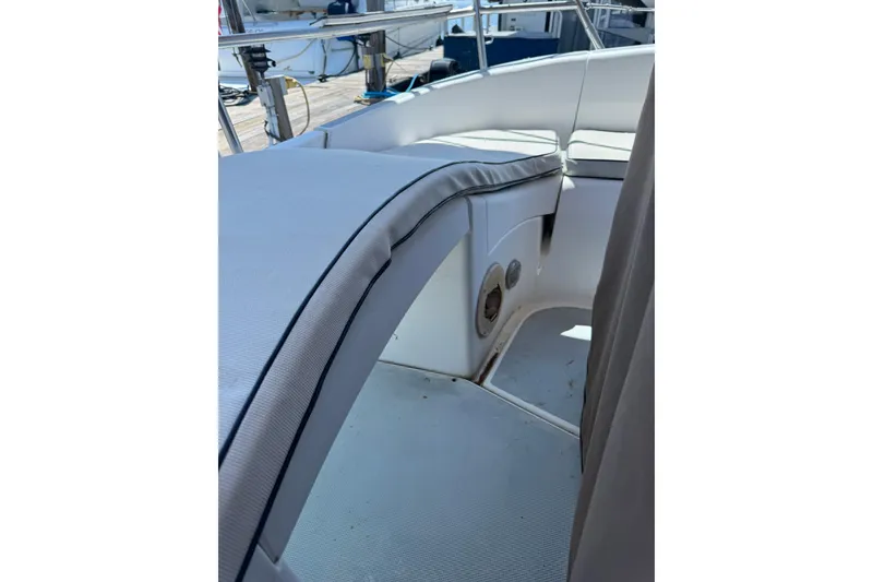 Slide: The Image of Interior view of a 1994 Hunter 29.5 sailboat cockpit with cushioned seating. - 12
