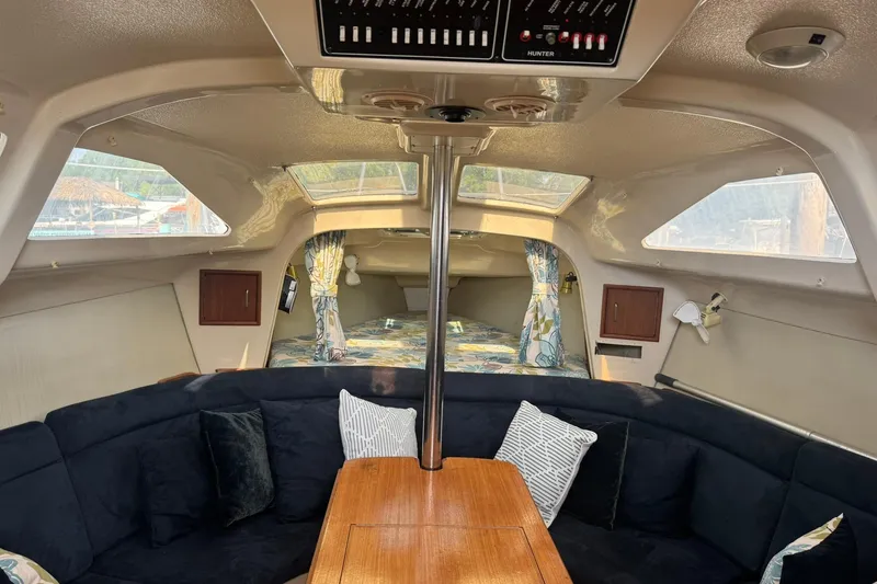 Slide: The Image of Interior of a 1994 Hunter 29.5 sailboat with cozy seating and wooden table. - 15