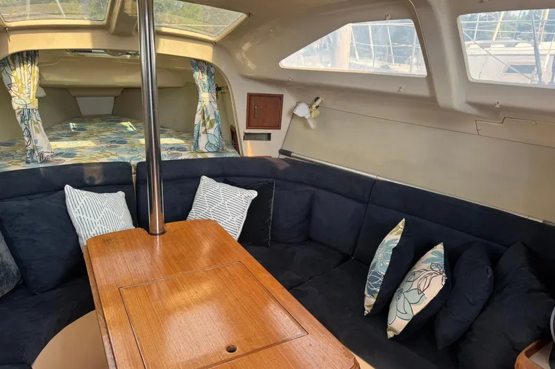 Slide: The Image of Interior of a 1994 Hunter 29.5 sailboat with cozy seating and decorative pillows. - 16