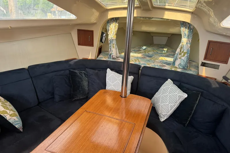Slide: The Image of Interior of a 1994 Hunter 29.5 sailboat with cozy seating and decorative pillows. - 17
