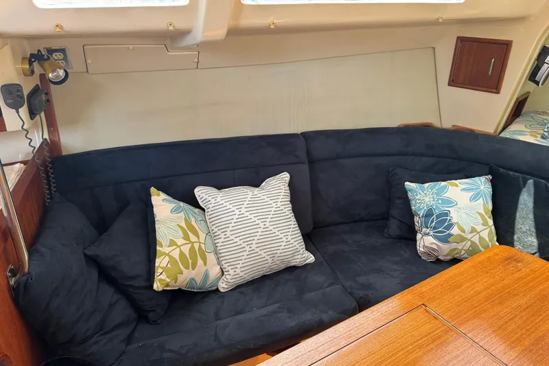 Slide: The Image of Cozy interior of 1994 Hunter 29.5 sailboat with plush seating and decorative pillows. - 20