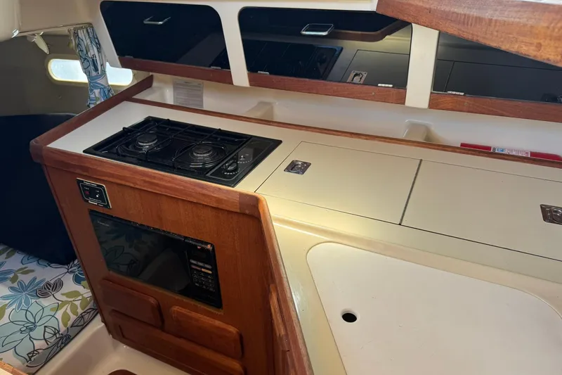 Slide: The Image of Interior of a 1994 Hunter 29.5 sailboat kitchen with stove and microwave. - 25
