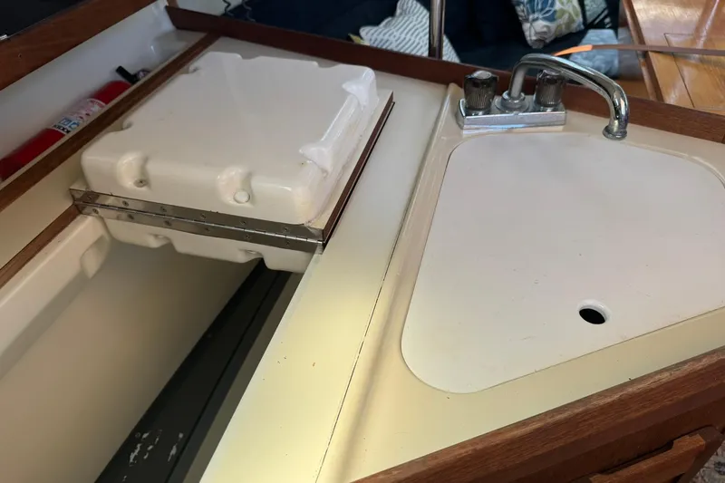 Slide: The Image of 1994 Hunter 29.5 sailboat galley with sink and storage compartment. - 27