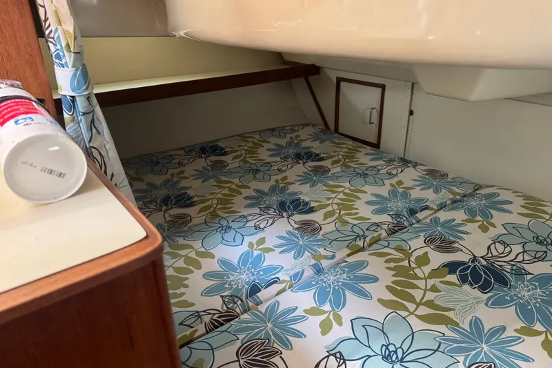 Slide: The Image of Cozy cabin interior of 1994 Hunter 29.5 sailboat with floral-patterned bedding. - 32