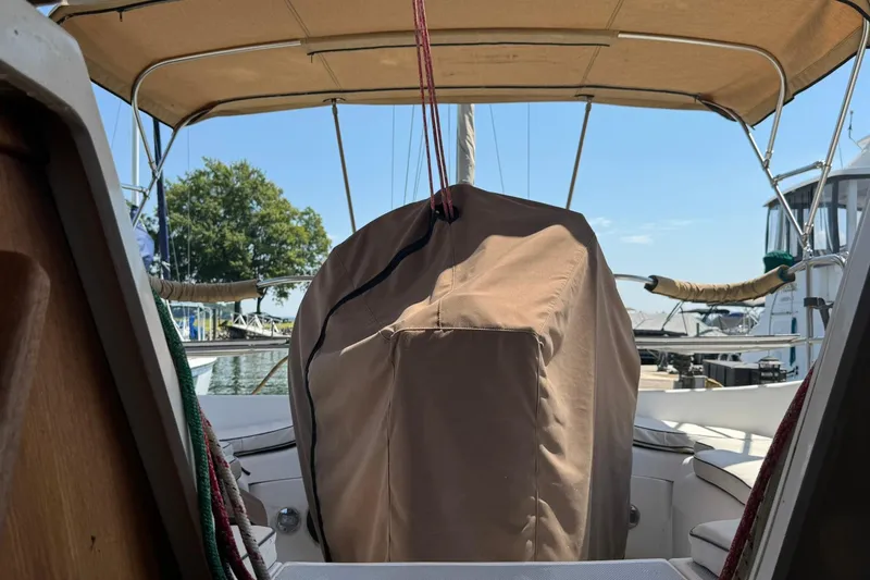 Slide: The Image of 1994 Hunter 29.5 sailboat cockpit with covered helm, docked at marina. - 6