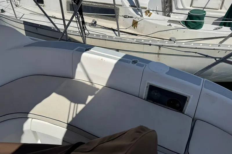 Slide: The Image of Cockpit view of a 1994 Hunter 29.5 sailboat, featuring cushioned seating and nautical equipment. - 7