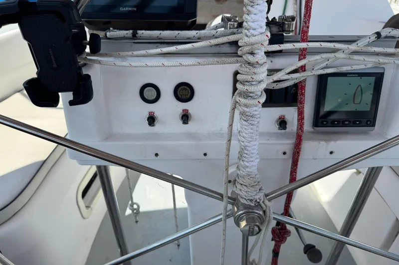 Slide: The Image of Cockpit controls of a 1994 Hunter 29.5 sailboat with navigation instruments. - 8
