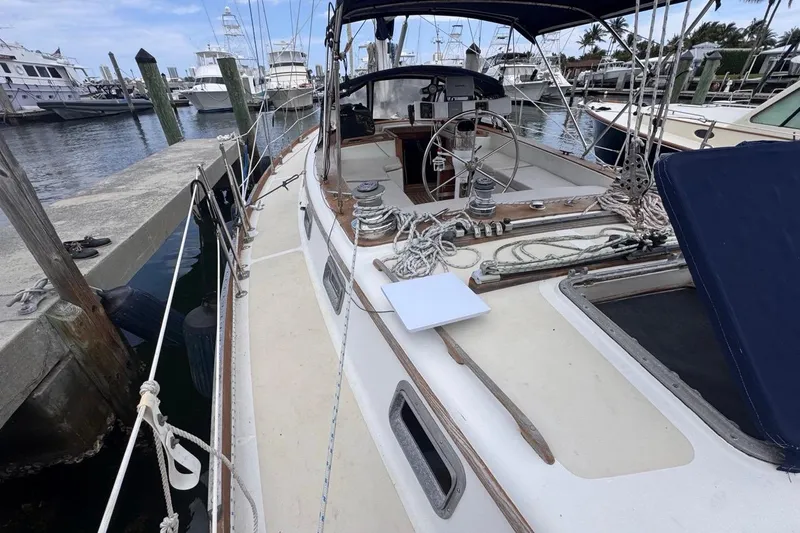 Slide: The Image of 1981 Gulfstar 44 Mk II Center Cockpit Sloop docked at marina, showcasing deck and cockpit. - 19