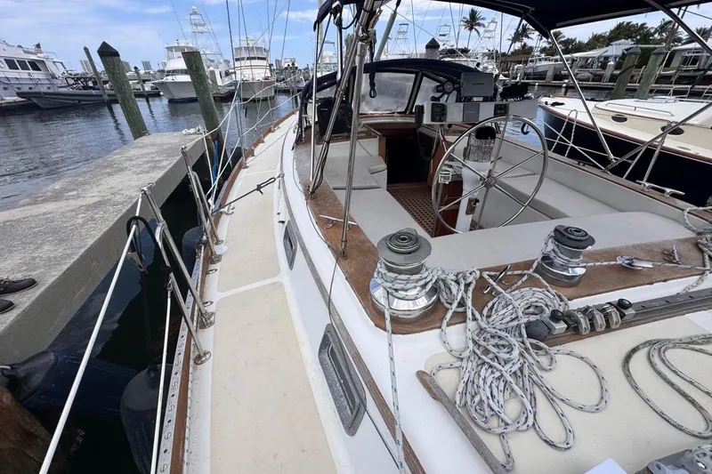 Slide: The Image of 1981 Gulfstar 44 Mk II Center Cockpit Sloop docked at marina, showcasing deck and helm. - 20