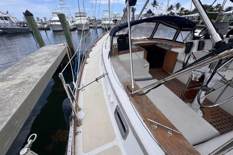 Slide: The Image of 1981 Gulfstar 44 Mk II Center Cockpit Sloop docked at marina, showcasing deck and cockpit. - 21