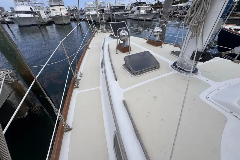 Slide: The Image of 1981 Gulfstar 44 Mk II Center Cockpit Sloop docked at marina, showcasing deck and rigging. - 23