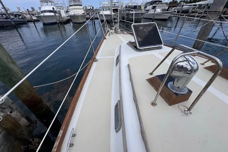 Slide: The Image of 1981 Gulfstar 44 Mk II Center Cockpit Sloop docked at marina, view of deck and winch. - 27