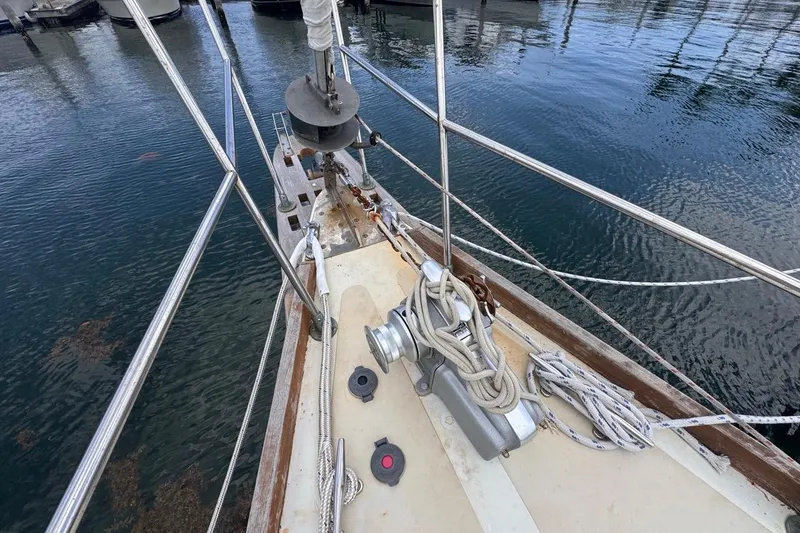 Slide: The Image of 1981 Gulfstar 44 Mk II Center Cockpit Sloop bow with ropes and winch in marina. - 29