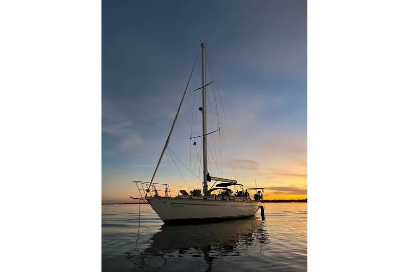 Slide: The Image of 1981 Gulfstar 44 Mk II Center Cockpit Sloop docked, featuring sleek design and spacious deck. - 3