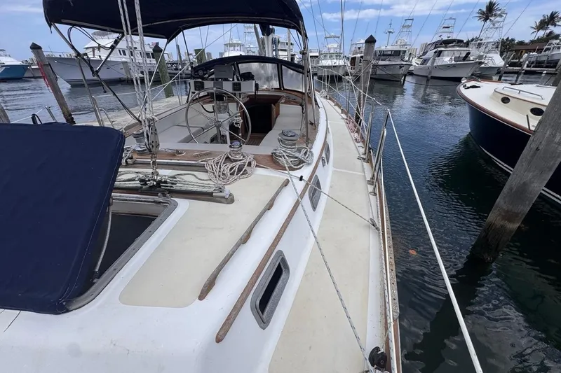 Slide: The Image of 1981 Gulfstar 44 Mk II Center Cockpit Sloop docked at marina, showcasing deck and cockpit. - 30
