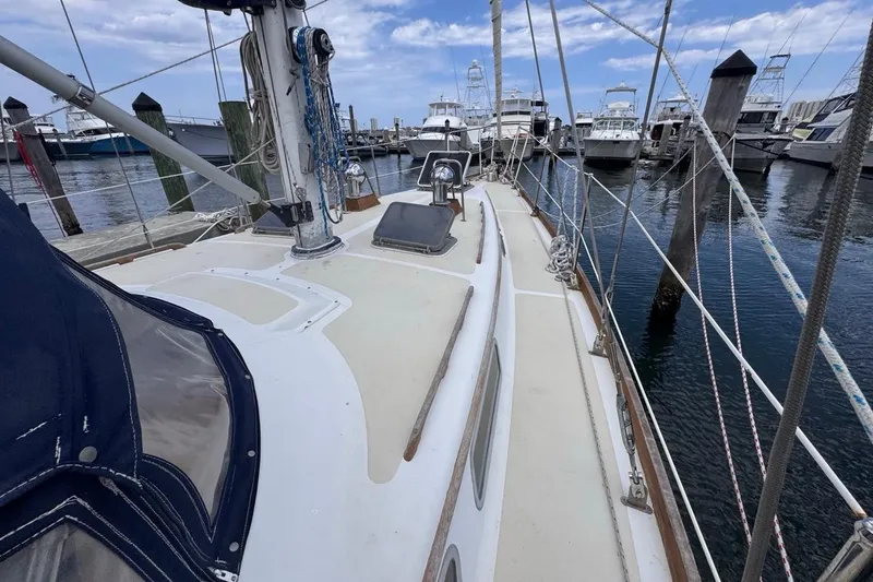 Slide: The Image of 1981 Gulfstar 44 Mk II Center Cockpit Sloop docked at a marina, showcasing deck and rigging. - 34