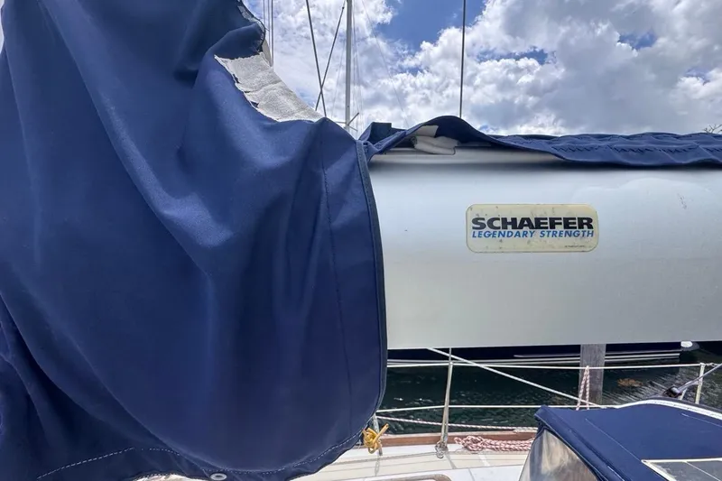 Slide: The Image of 1981 Gulfstar 44 Mk II Sloop with Schaefer rigging, blue sail cover, and cloudy sky. - 40
