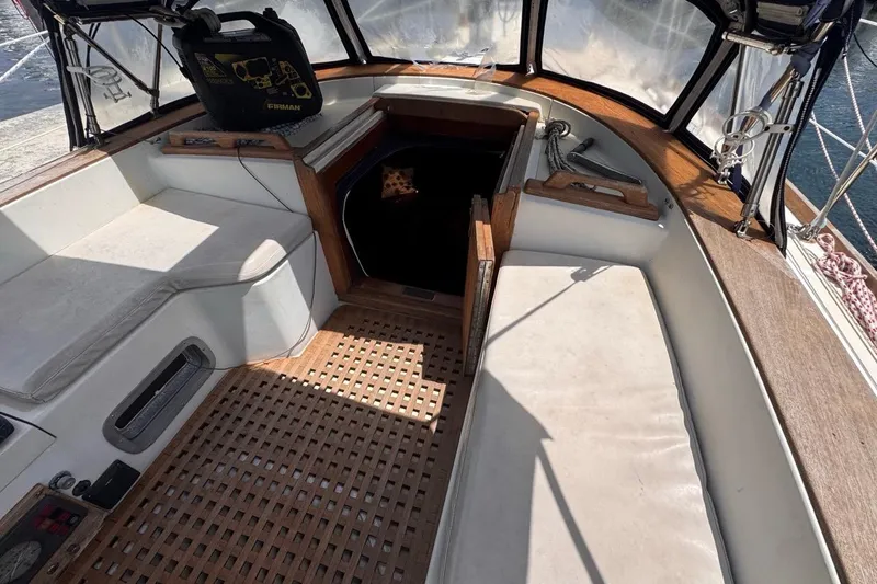 Slide: The Image of 1981 Gulfstar 44 Mk II Center Cockpit Sloop interior with seating and wooden flooring. - 46
