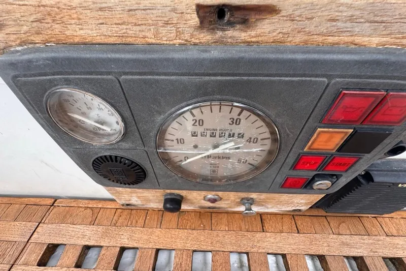 Slide: The Image of Control panel of a 1981 Gulfstar 44 Mk II Center Cockpit Sloop with gauges and buttons. - 47