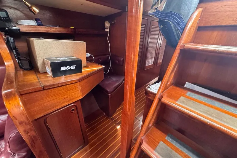 Slide: The Image of Interior of 1981 Gulfstar 44 Mk II Sloop with wooden cabinetry and navigation equipment. - 52