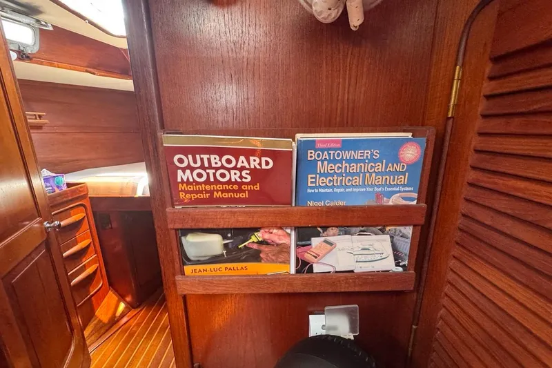 Slide: The Image of Interior of 1981 Gulfstar 44 Mk II with maintenance manuals on wooden shelf. - 55