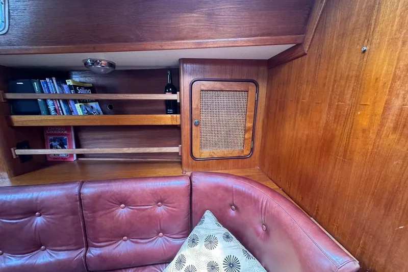 Slide: The Image of Interior of 1981 Gulfstar 44 Mk II Sloop with bookshelves and red leather seating. - 58