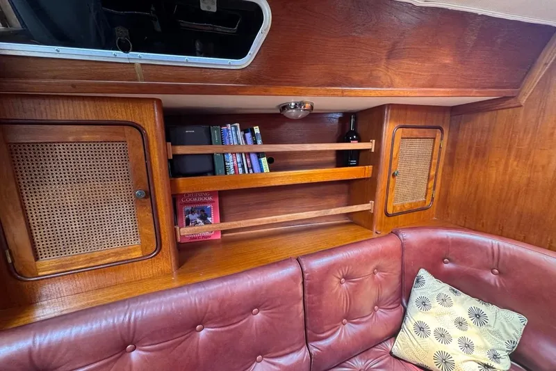 Slide: The Image of Interior of 1981 Gulfstar 44 Mk II Sloop with wooden shelves and red leather seating. - 60