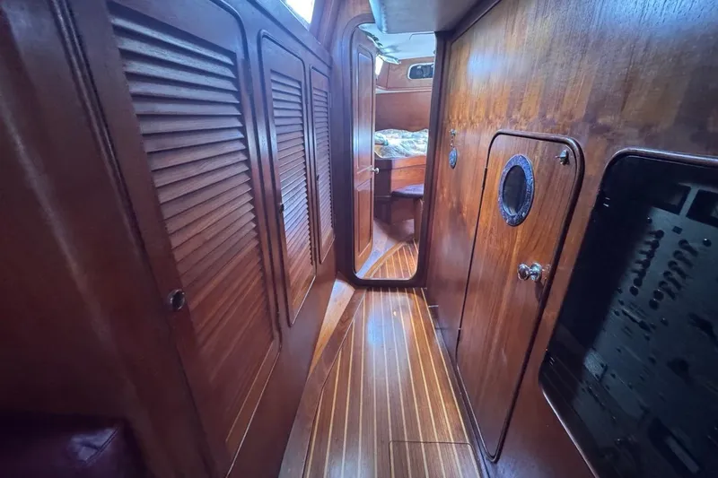Slide: The Image of Interior of 1981 Gulfstar 44 Mk II Sloop, featuring wooden paneling and cozy cabin space. - 62