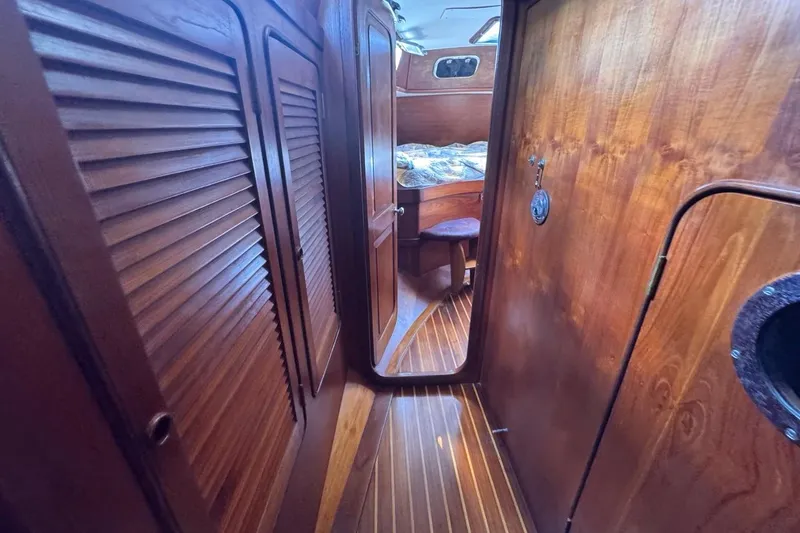 Slide: The Image of Interior of 1981 Gulfstar 44 Mk II Sloop, featuring wooden cabinetry and cozy cabin space. - 63