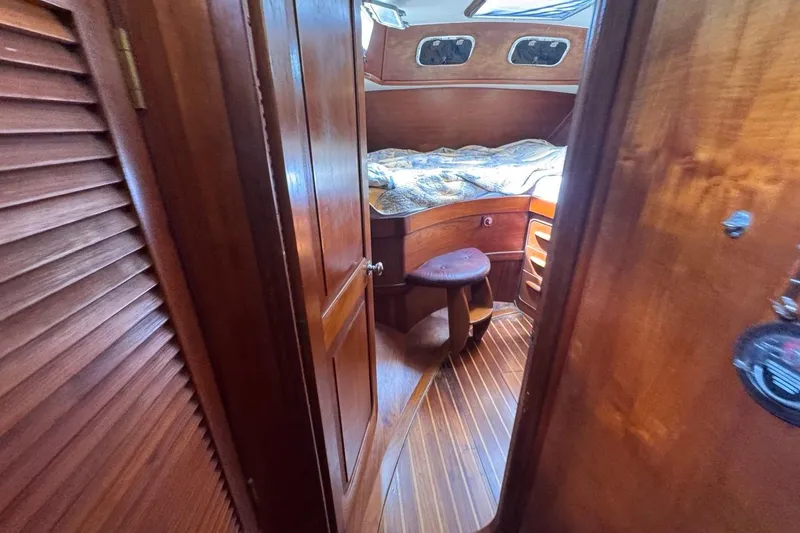 Slide: The Image of Interior of 1981 Gulfstar 44 Mk II Sloop, featuring wooden cabin and cozy sleeping area. - 64
