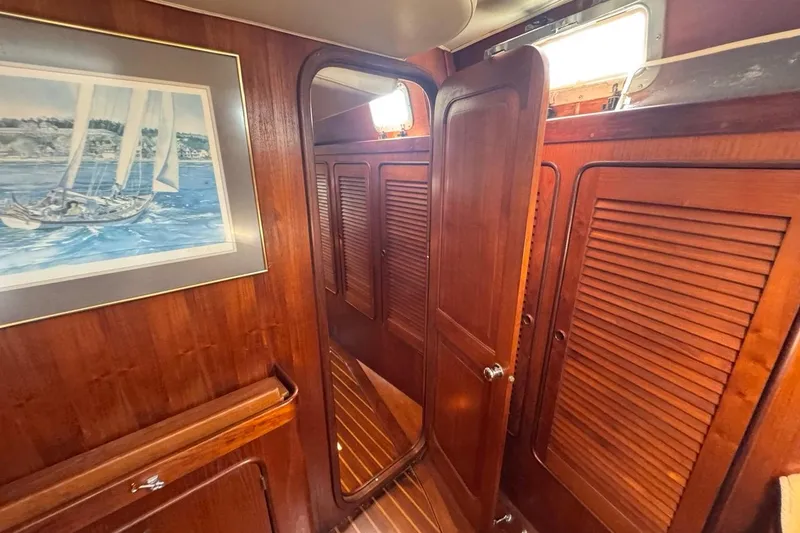 Slide: The Image of Interior of 1981 Gulfstar 44 Mk II Sloop with wooden paneling and nautical artwork. - 68