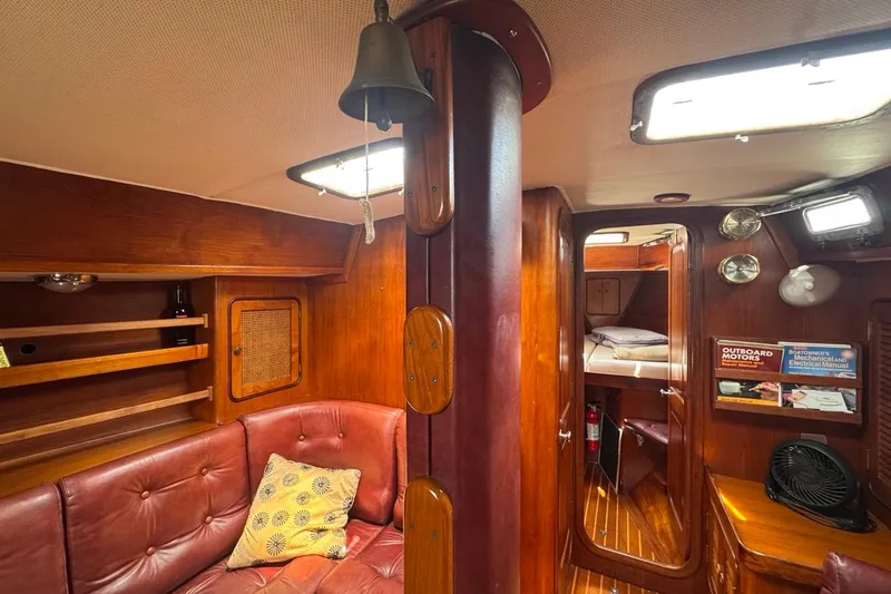Slide: The Image of Interior of 1981 Gulfstar 44 Mk II Sloop, featuring cozy seating and wooden cabinetry. - 74