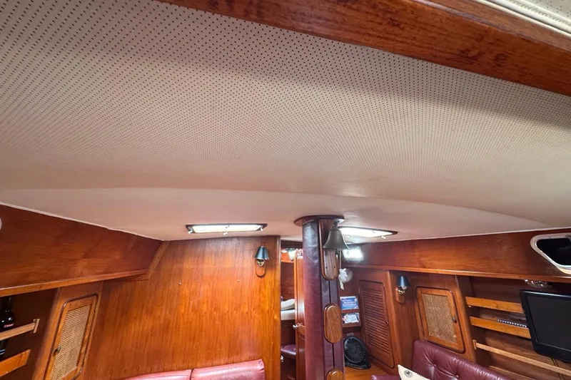 Slide: The Image of Interior of 1981 Gulfstar 44 Mk II Sloop, featuring wood paneling and cozy seating area. - 77
