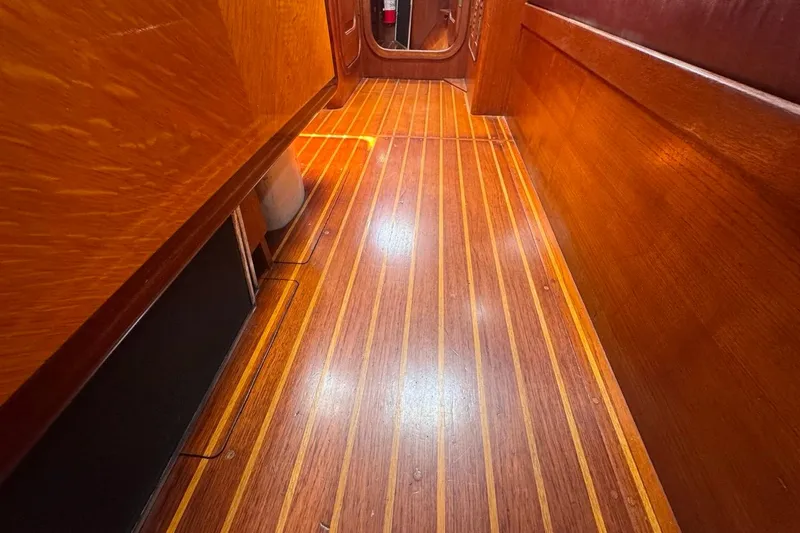 Slide: The Image of Teak wood flooring inside 1981 Gulfstar 44 Mk II Center Cockpit Sloop yacht. - 78