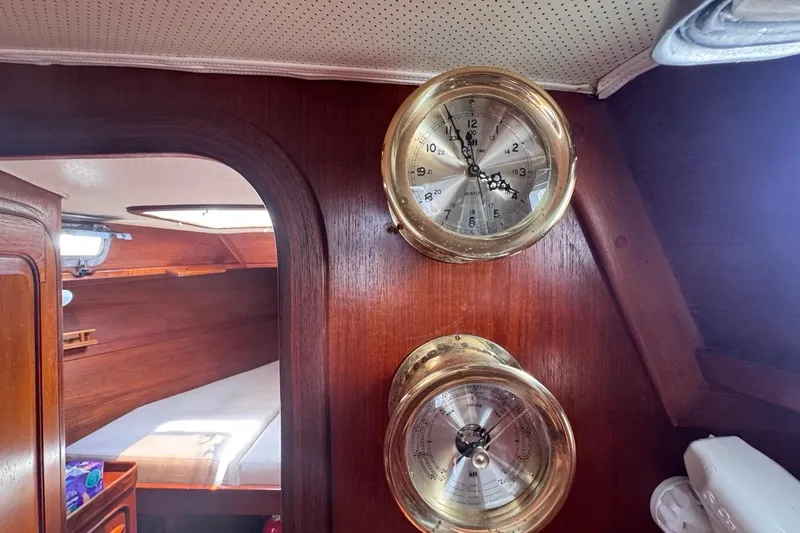 Slide: The Image of Interior of 1981 Gulfstar 44 Mk II Sloop with brass clock and barometer on wooden wall. - 79