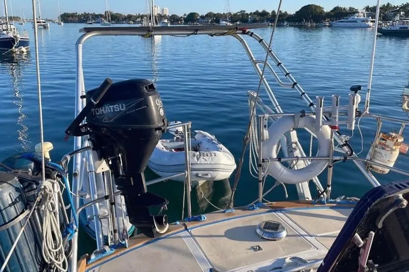 Slide: The Image of 1981 Gulfstar 44 Mk II Center Cockpit Sloop docked at a marina under a partly cloudy sky. - 8