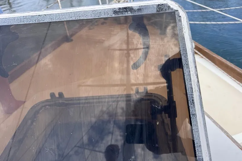 Slide: The Image of Hatch detail on 1981 Gulfstar 44 Mk II Center Cockpit Sloop, reflecting sky and rigging. - 80