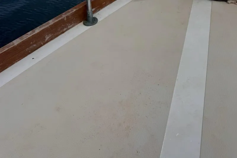 Slide: The Image of Deck of 1981 Gulfstar 44 Mk II Center Cockpit Sloop with wooden trim and railing. - 81